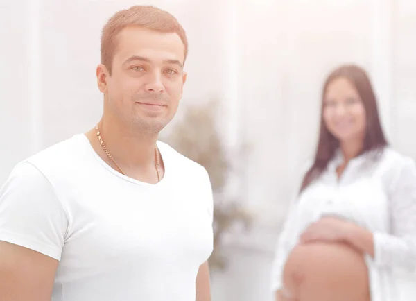 Closeup of husband and pregnant wife ,standing in the new living — Stock Photo, Image