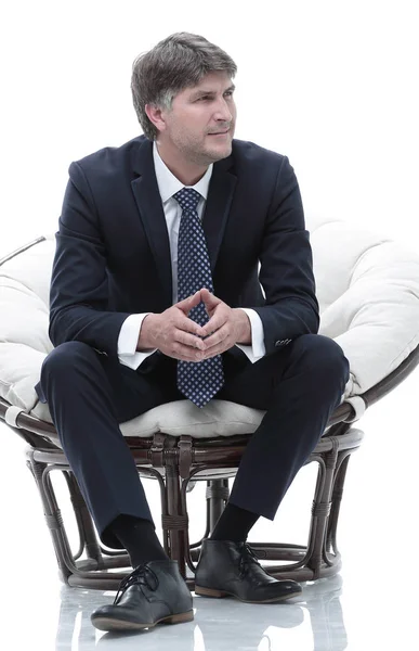 Tired business man sitting in a large comfortable chair — Stock Photo, Image