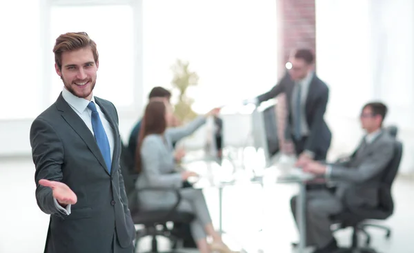 Businessman with hand in a welcoming gesture at the office — Stock Photo, Image