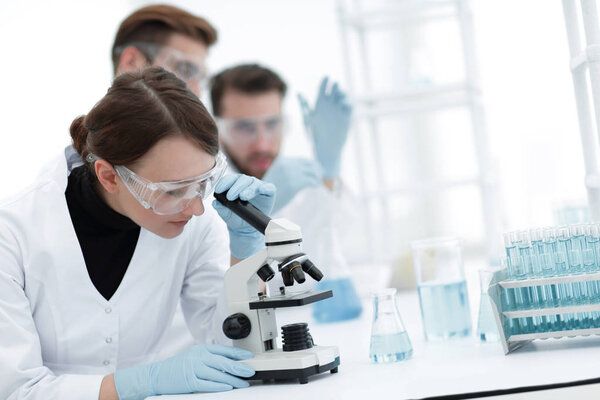 female scientists looking into a microscope
