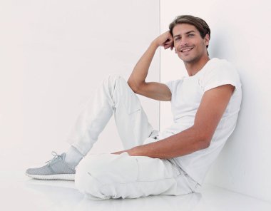 Beyaz bir duvar oturan endişeli adam