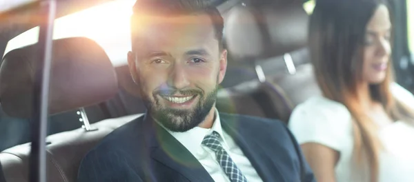 Handsome business man and his partner in the car — Stock Photo, Image