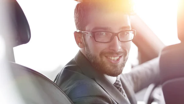 Man in formalwear sitting in car — Stock Photo, Image