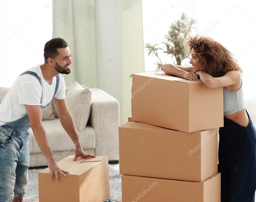 Happy and young couple looking at boxes