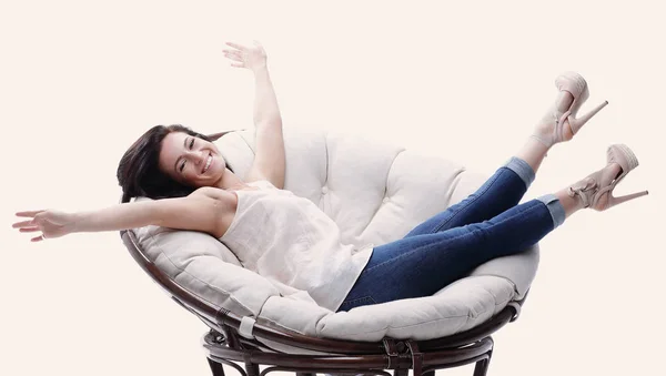 Modern young woman relaxing in a round cozy soft chair — Stock Photo, Image