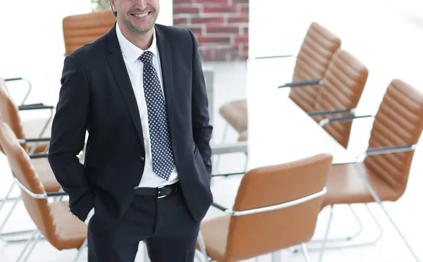 Business man standing in an empty meeting room — Stock Photo, Image