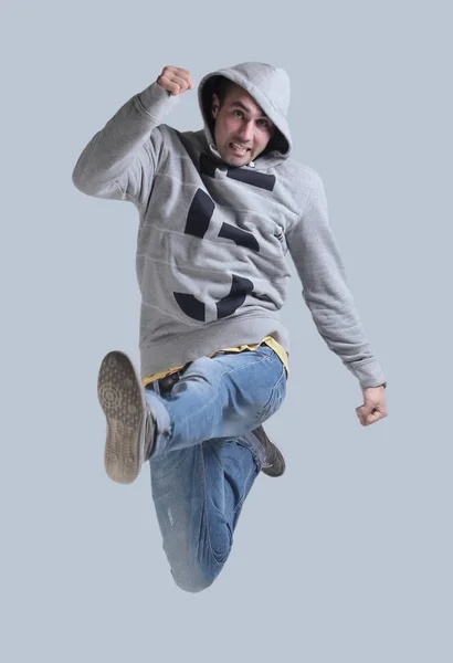 Funny cheerful happy man jumping in air over gray background — Stock Photo, Image