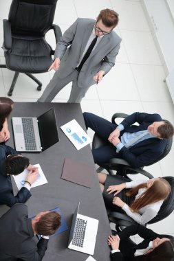 Proje Yöneticisi, iş ekibiyle bir brifing veriyor.