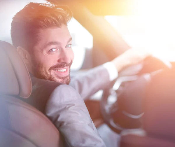 Successful man sitting behind the wheel of a prestigious car — Stock Photo, Image