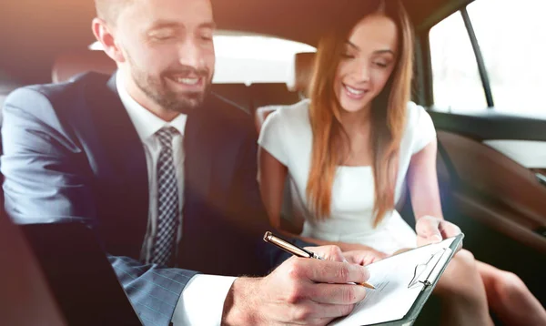 Schöne Geschäftsfrau arbeitet mit einem Kunden im Auto — Stockfoto