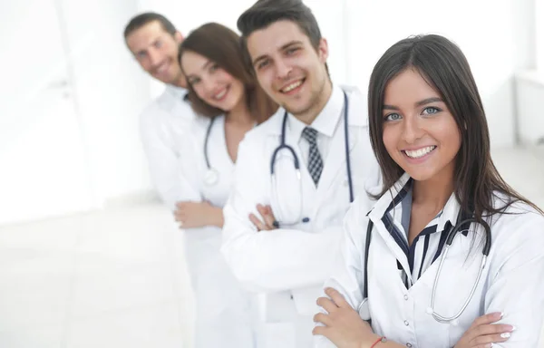 Female doctor with group of happy successful colleagues — Stock Photo, Image