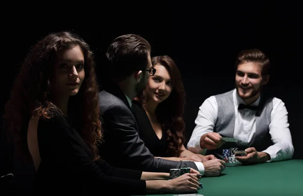 Players sitting at the playing table in the casino — Stock Photo, Image