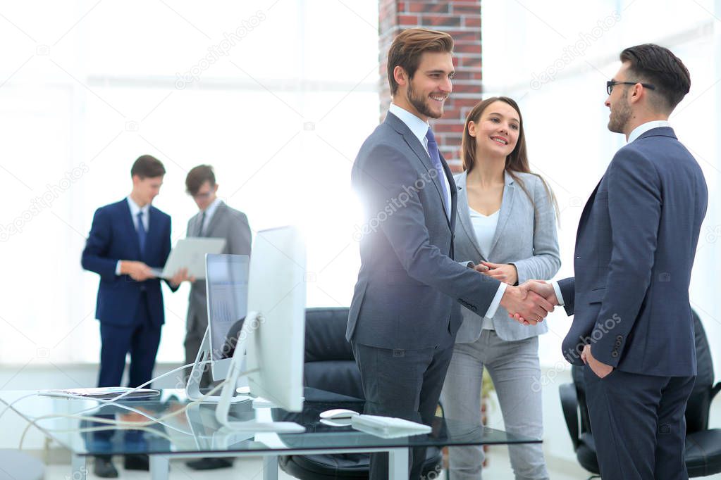 handshake business partners at a meeting