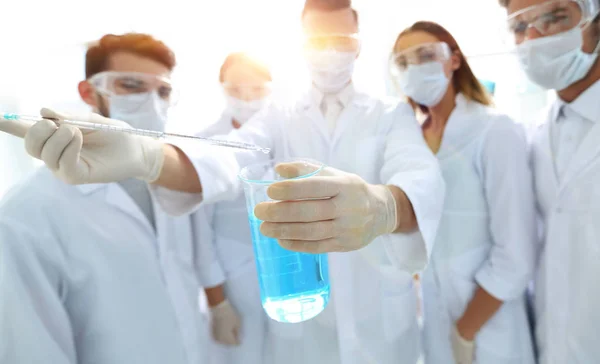 Closeup of a group of medical workers working with liquids — Stock Photo, Image