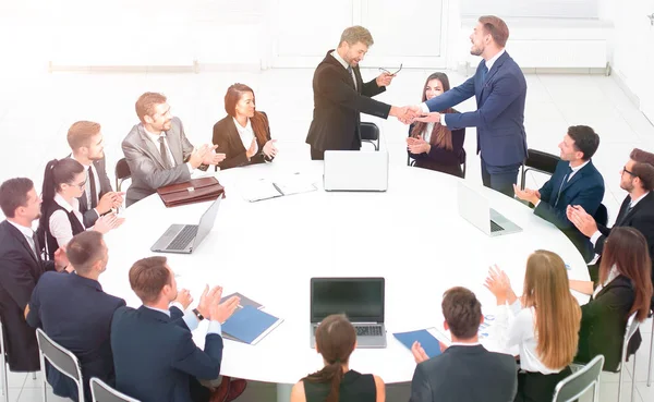 Бізнес-партнери тремтять руками на переговорах біля круглого столу — стокове фото