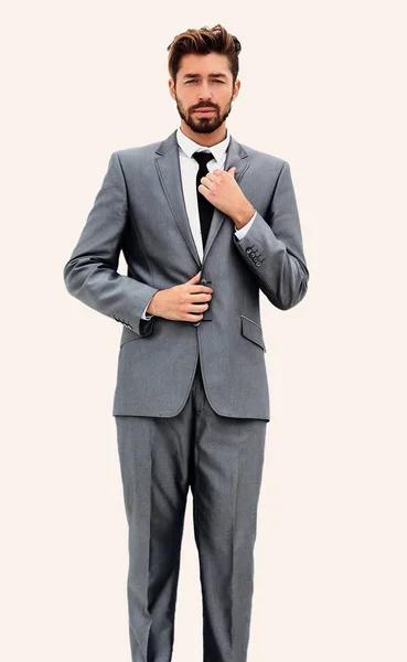 Man in suit straightens collar, portrait on white background — Stock Photo, Image