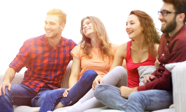 Group of cheerful friends sitting on the couch — Stock Photo, Image