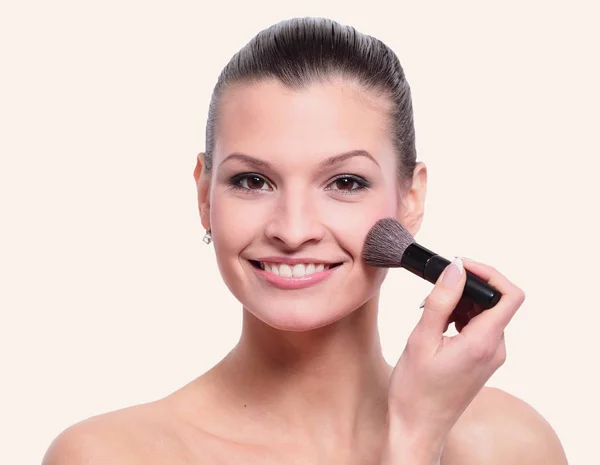 Woman applying dry cosmetic tonal foundation on the face using m — Stock Photo, Image