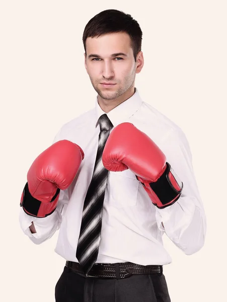 Business man with boxing gloves is ready for corporate battle. Royalty Free Stock Photos