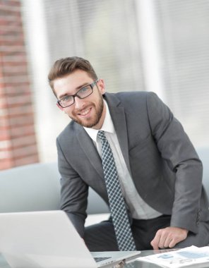 Masasında oturan modern bir işadamı portresi.