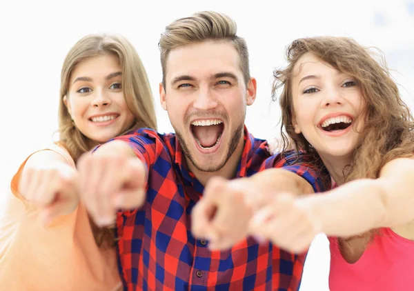 Closeup of three happy young people showing hands forward — Stock Photo, Image