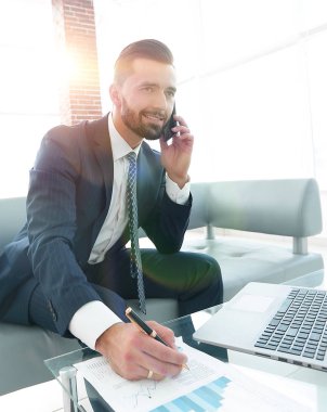 İşadamı Smartphone'da finansal belgeler hakkında konuşmak