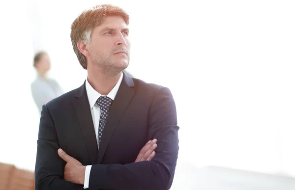 Confident businessman stands and looks away. — Stock Photo, Image