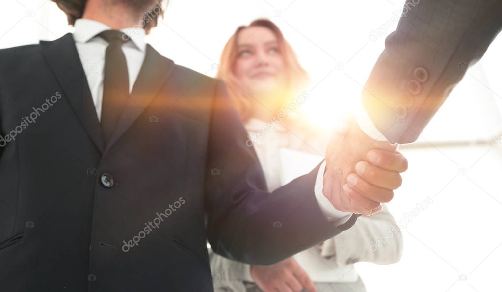 Photo of handshake of two happy businessmen