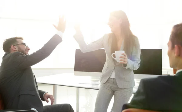 smiling colleagues giving each other high five