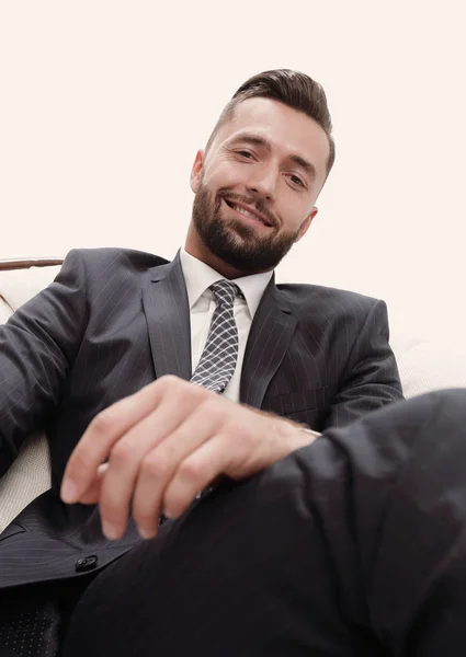 Confident businessman sitting in a chair — Stock Photo, Image