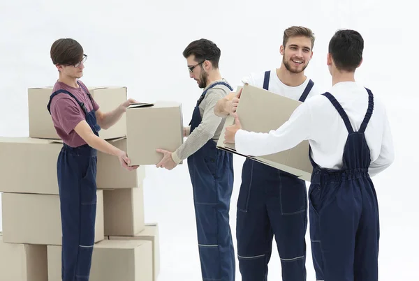 Movers lifting stack of cardboard moving boxes isolated on white — Stock Photo, Image