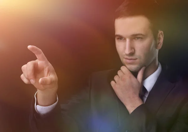 Businessman pointing to a blank spot.isolated on a black backgro — Stock Photo, Image