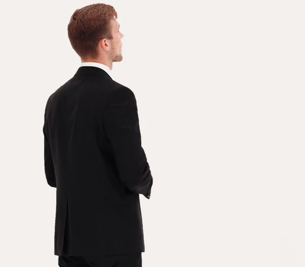 Rear view. young businessman looks ahead. — Stock Photo, Image