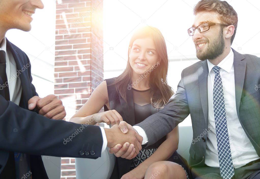 handshake Manager and the client at a meeting in the office lobb