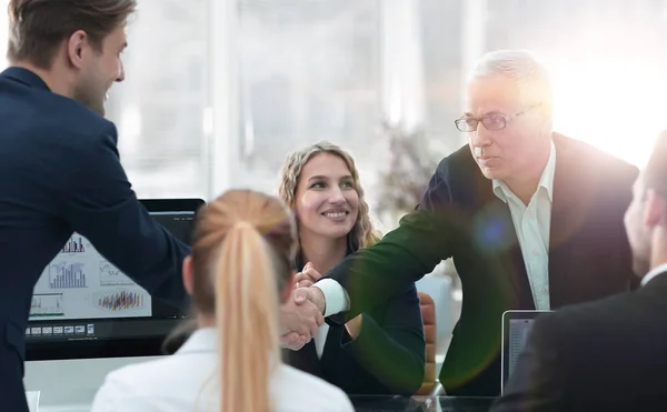 Business partners shake hands in the conference room — Stock Photo, Image