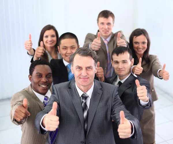 Happy business team holding thumbs up — Stock Photo, Image