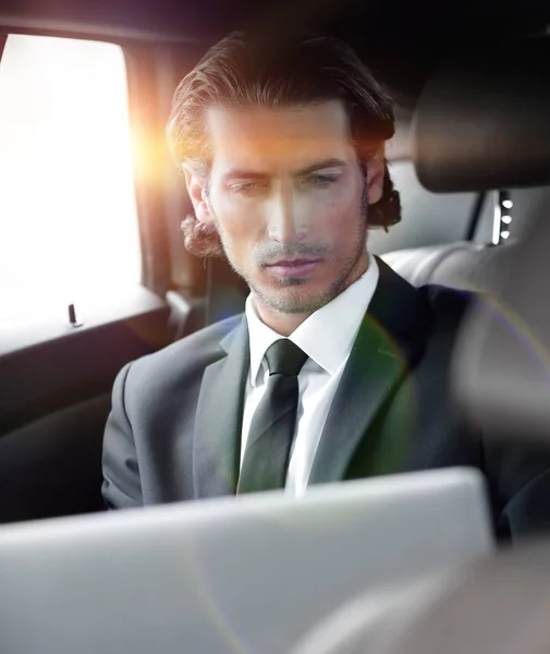 Man working on laptop while sitting in the car — Stock Photo, Image