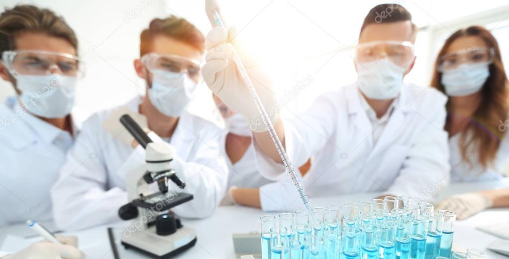 Scientists at chemical laboratory during work