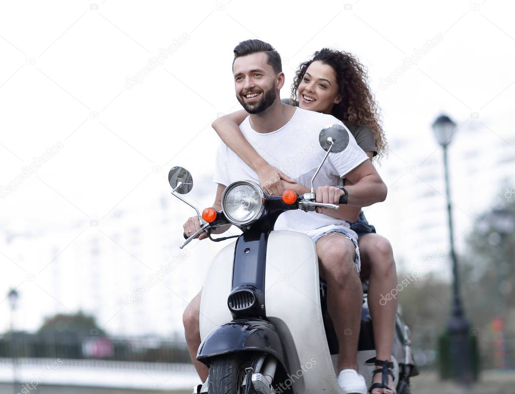 Happy cheerful couple riding vintage scooter. Travel concept.