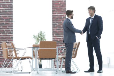 İki iş adamları el ofiste sallamak.