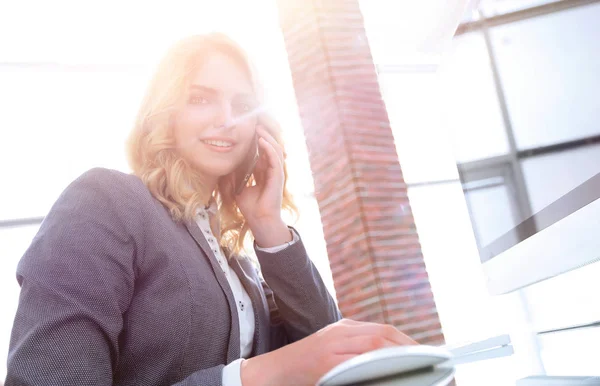 Geschäftsfrau spricht im Büro auf Smartphone — Stockfoto