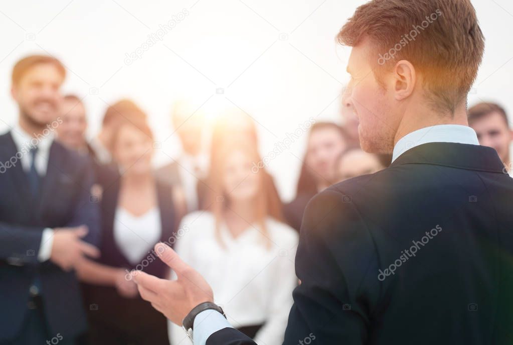 businessman makes a speech to his team.