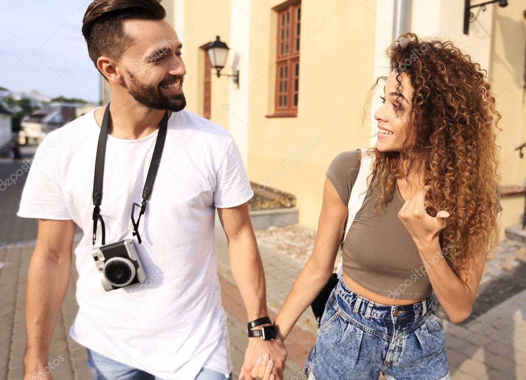 Couple of tourists look at each other and walking