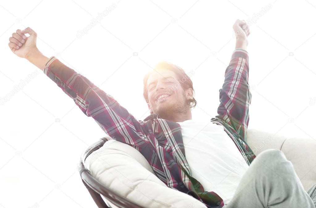 stylish guy stretching in a comfortable chair