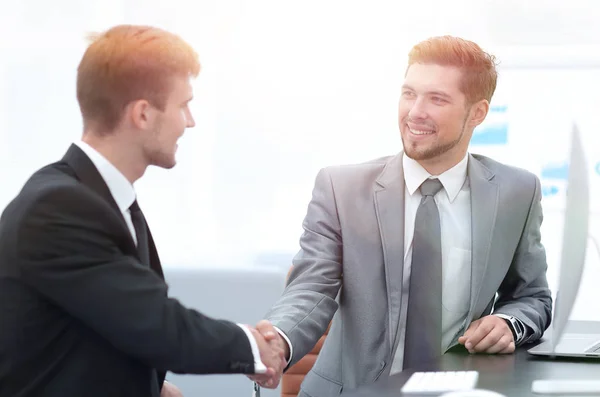 Handshake of business partners sitting at a Desk. — Stock Photo, Image