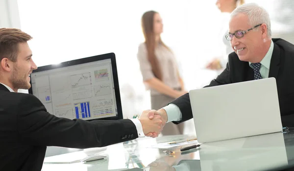 businessman welcomes business partner shaking hands