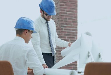 yeni bir projeyi tartışmak üzere mimar ve inşaat ustabaşı