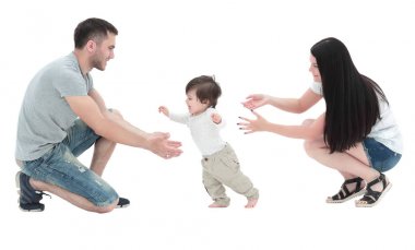 little boy making  first steps with the help of parents clipart