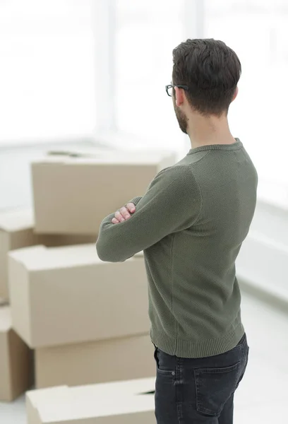 rear view.a man looks at boxes of stuff.