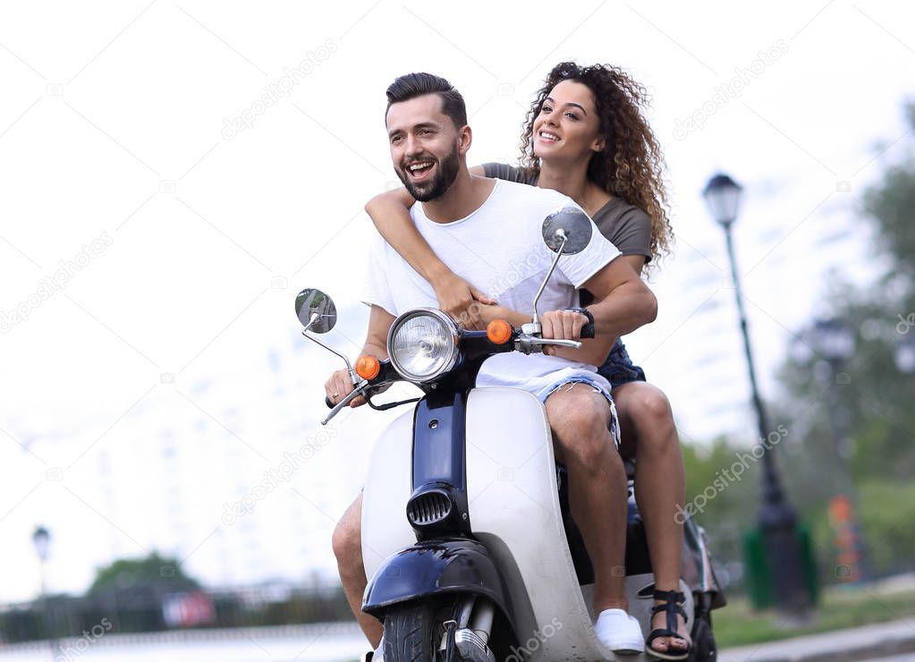 Happy cheerful couple riding vintage scooter. Travel concept.